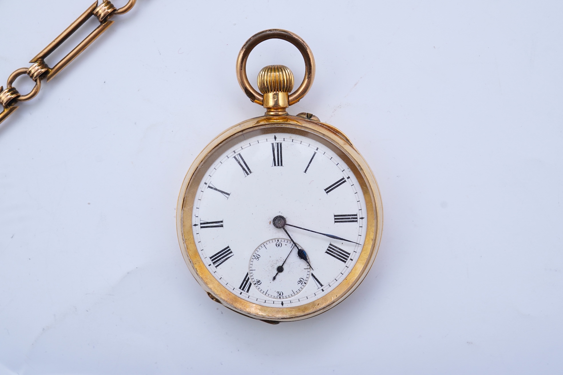 A continental 18k gold open faced keyless lever pocket watch, with a 9ct albert